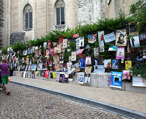 Avignon, France - July 13, 2011: Hundreds of colourful posters line the sidewalks for the famous festival of Avignon.